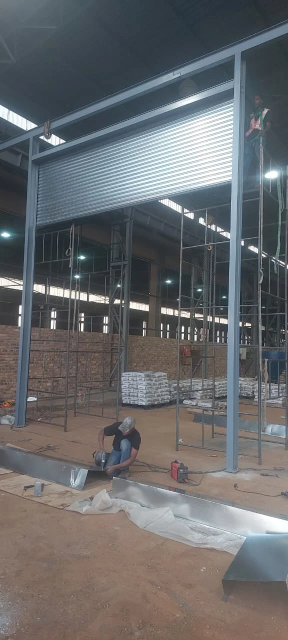 New opening, new roller door: The finished door hanging in its fabricated steel frame — we built the opening and the roller shutter as one package.