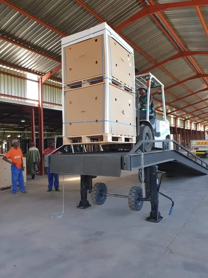 Mobile yard ramp in daily use: A forklift carrying stacked pallets straight up one of our mobile yard ramps into a warehouse loading area.