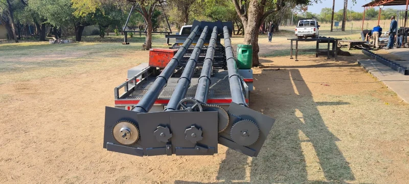 Barrel shafts with chain drives: Workshop-built barrel shafts with chain-drive sprockets and end plates — the heavy parts that keep an industrial door lifting smoothly.